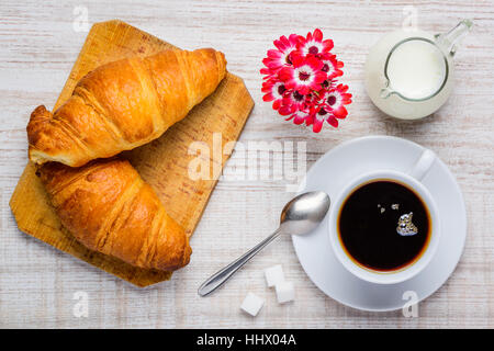 Two croissants and a cup of coffee with suggar and milk Stock Photo
