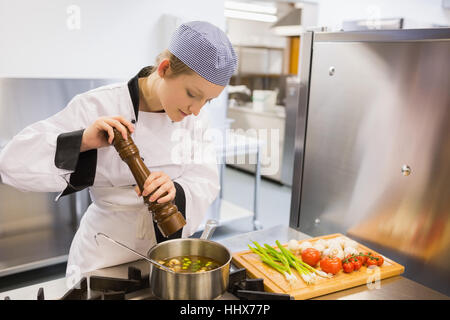 Chef stirring soup in large pot on stove available as Framed Prints,  Photos, Wall Art and Photo Gifts