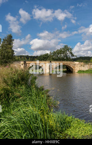 Old stone bridge over the river Derwent beside Kirkham Priory in North Yorkshire. Stock Photo