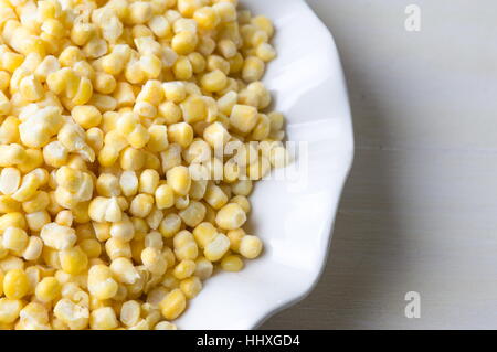 Frozen sweet corn in a bowl on a table Stock Photo