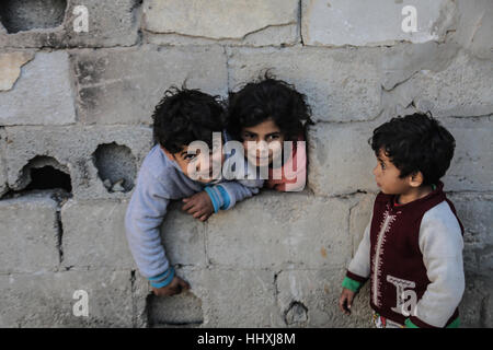 Saftawi, Gaza. 19th Jan, 2017. January 19, 2017 - Gaza City, Gaza Strip, Palestine - Palestinian boys playing outside the family's home for refugees in the streets of Saftawi neighborhood in the northern Gaza Strip, January 19, 2017. Palestinian boys playing outside the family's home for refugees in the streets of Saftawi neighborhood in the northern Gaza Strip. Credit: Nidal Alwaeidi/Pacific Press/Alamy Live News Stock Photo