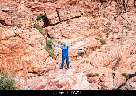 Adult man expressing freedom on a rock at Red Rock Canyon National Conservation Area, Las Vegas, Nevada, USA. Stock Photo