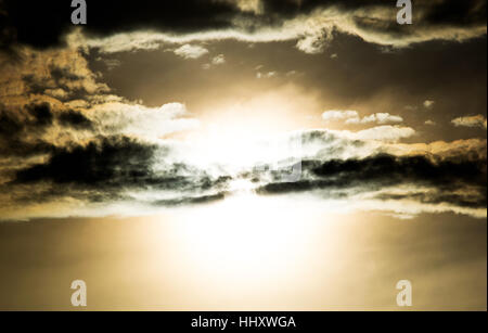 clouds in the evening with the sun shining through at sunset Stock Photo