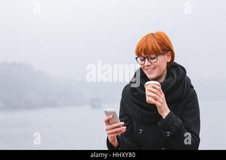Young modern business woman. Portrait of young girl who checks smartphone. Stock Photo