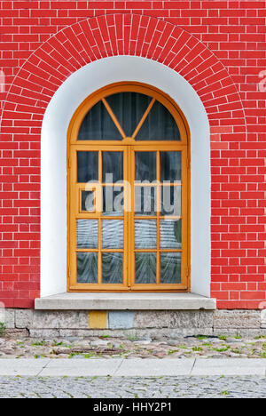 Window with arch in the background of wall of red brick. From the series window of Saint-Petersburg. Stock Photo