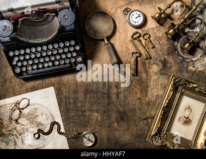 Vintage typewriter and old office accessories on wooden table. Nostalgic still life Stock Photo