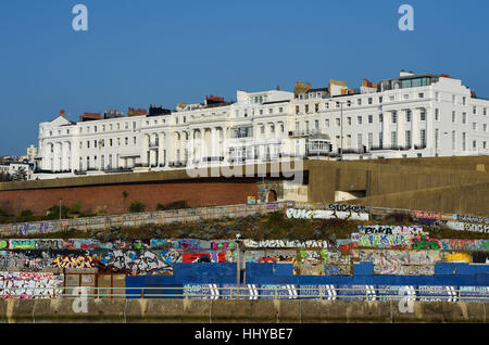 Arundel Terrace typical Regency style properties on Brighton seafront with the Black Rock waste ground covered in graffiti in foreground  Photograph t Stock Photo