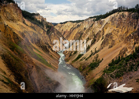 Mist from the Lower Falls and colorful Grand Canyon of the Yellowstone River from  Brink of the Lower Falls Overlook. Stock Photo