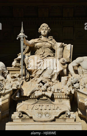 Goddess of Justice marble statue on throne with sword and book, in front of old Palace of Justice in Rome Stock Photo
