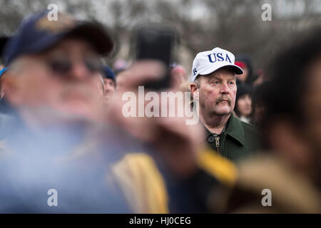 Washington, USA. 20th Jan, 2017 - A man listens to the speech of President Donald Trump during the inauguration ceremony in Washington, D.C. Credit: Gordon M. Grant/Alamy Live News