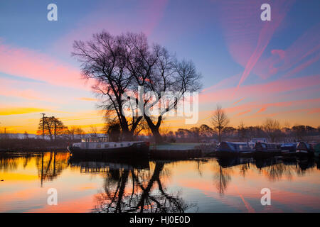Rufford, Lancashire, UK. 21st January, 2017. Cold & misty early morning at Rufford Marina, on the Leeds Liverpool canal, as the rising sun highlights aircraft vapour trails pointing out the route to Manchester airport. Credit: Cernan Elias/Alamy Live News Stock Photo