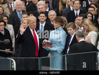 Washington, USA. 20th Jan, 2017. U.S. President Donald Trump takes the oath of office during the inauguration ceremony at the U.S. Capitol in Washington, DC, the United States, on Jan. 20, 2017. Donald Trump was sworn in on Friday as the 45th President of the United States. Credit: charlie archambault/Alamy Live News Stock Photo
