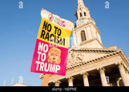 London, UK - 21 January 2017. Protest sign from Stand up to racism against Donald Trump. Thousands of protesters gathered in Trafalgar Square to attend Women's March against Donald Trump calling for human rights and equality. Stock Photo