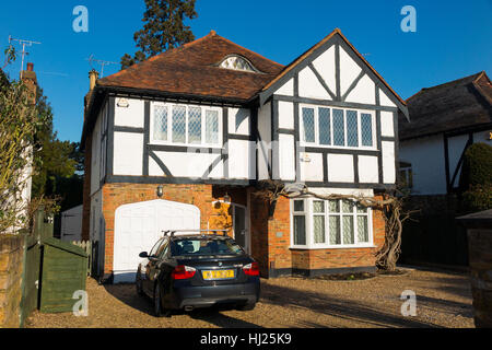 Mock Tudor 1930's house with car on the drive, and garage, in Esher, Surrey. UK. Stock Photo