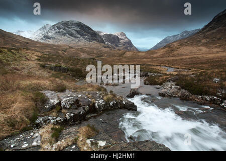 Area of Glencoe, Scotland. Picturesque dramatic view of Glencoe with the River Coe in the foreground. Stock Photo