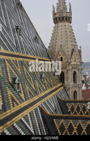 VIENNA, AUSTRIA - JANUARY 3 2016: Architectural close up of the roof and Steeple of Stephansdom cathedral from its top in Vienna, Austria Stock Photo