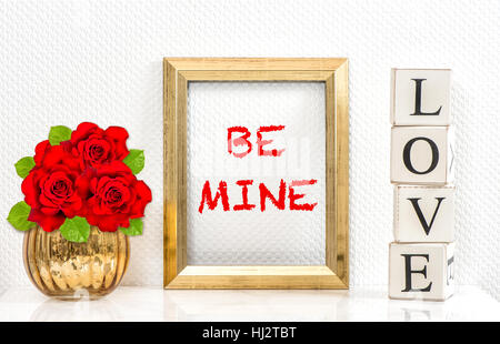 Golden frame and red roses. Greetings card with text Be Mine Stock Photo