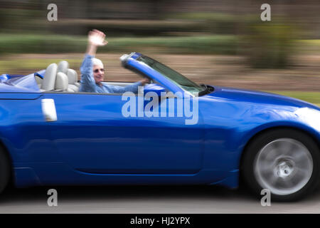Senior Man Driving  and Waving in Late Model Sports Car Convertible, USA Stock Photo
