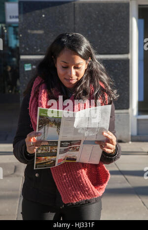 Foreign tourist reading map in Piccadilly, Manchester, UK Stock Photo