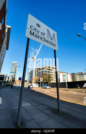 City of Manchester sign on Medlock Street, Manchester City centre with construction site in background. Stock Photo
