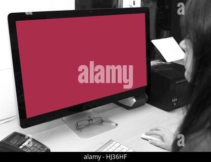 Creative girl sits at desk getting ready to start work on a new project. The blank screen represents the blank canvas all creatives are faces when sta Stock Photo
