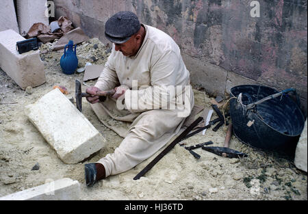 Turkish Stone Mason or Stone Cutter Cutting Stone in Cappadocia Turkey Stock Photo