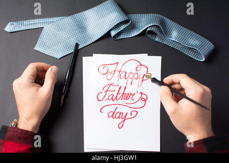 male hands writing a happy father's day note Stock Photo