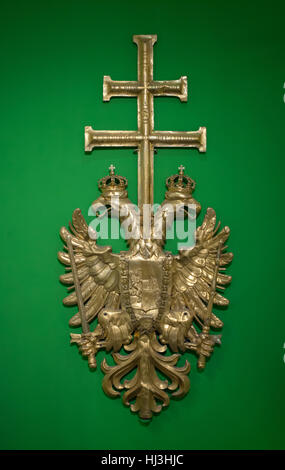 Coat of arms of the Austrian Empire from the bell tower of the Stephansdom (St Stephen's Cathedral) on display in the Wien Museum (Vienna Museum) in Vienna, Austria. The gilded eagle was installed on the bell tower of the cathedral from 1842 to 1860 and then replaced to the new one. Stock Photo