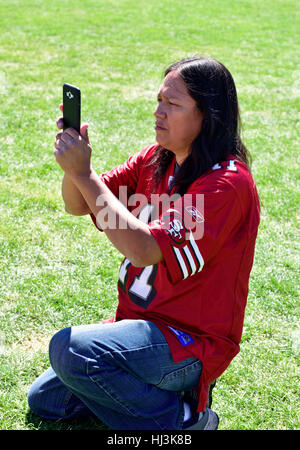 Navaho Native American Indian man at Prescott Inter-tribal Pow Wow Arizona taking photo with cell phone Stock Photo