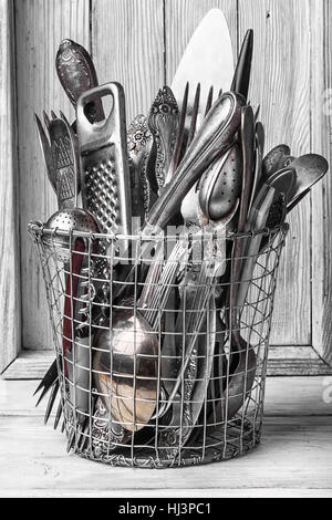 Set of table accessories of forks,spoons and knives in the wicker basket Stock Photo
