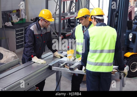 Workers in uniform in CNC machine shop with lathes Stock Photo
