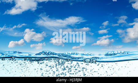 Many air bubbles in water close up, abstract water wave with bubbles on a background of blue sky Stock Photo