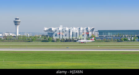 Panoramic view of Munich airport is named in memory of Franz Josef Strauss with passenger jet plane of Austrian Airlines. Stock Photo