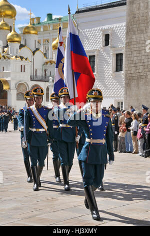 The Honor Guard Approaches. An honor guard carrying flags of Russian Federation on Cathedral Square in Moscow Kremlin. Russia. Stock Photo