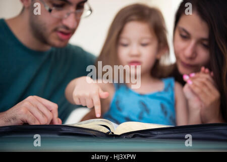 Young family studying the Word of God Stock Photo