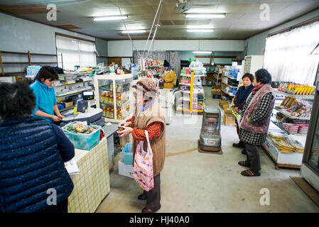 Locals of the Ainoshima Island community make purchases at the island's only grocery store one chilly winter morning Stock Photo