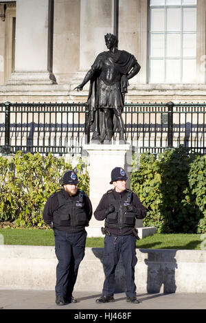 An armed metropolitan police officer standing guard outside the Houses ...