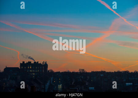 Dawn with a school on the horizon with smoke coming from the chimney Stock Photo