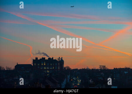 Dawn with a school on the horizon with smoke coming from the chimney Stock Photo