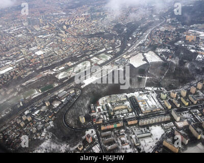 Velky Haj Forest and the South Connection Highway in Prague, Czech Republic. Aerial view pictured from the aircraft. The South Connection Highway (Jizni spojka) is the road in the middle. The Novodvorska Plaza Shopping Mall is seen in the bottom right. Football and baseball fields are seen between the highway and the valley of the Kunraticky Brook (Kunraticky potok). Districts over the highway are Pankrac and Krc. The Pankrac skyscrapers are seen in the left in the distance. Stock Photo