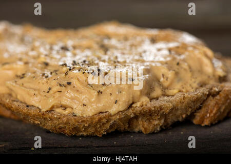 Close up of bread slice with homemade pork liver pate on wooden background Stock Photo