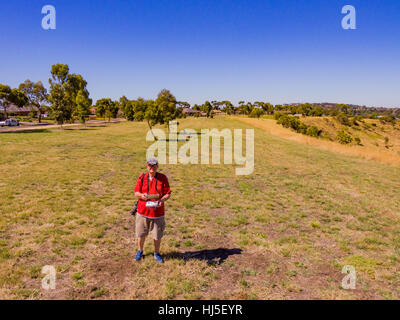 Man using radio control equipment to control a drone. Stock Photo