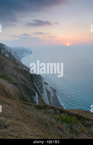 View from White Nothe, Dorset, UK. A colourful winter sunrise looking east along the Purbeck Jurassic Coastline from high up on White Nothe in Dorset. © Dan Tucker/Alamy Live News Stock Photo