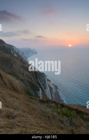 View from White Nothe, Dorset, UK. A colourful winter sunrise looking east along the Purbeck Jurassic Coastline from high up on White Nothe in Dorset. © Dan Tucker/Alamy Live News Stock Photo
