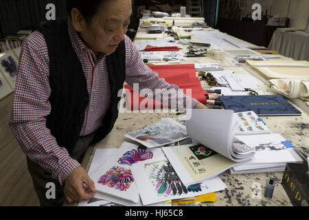 (170126) -- BEIJING, Jan. 26, 2017 (Xinhua) -- Chinese artist Han Meilin, 80, shows his sketches of roosters and hens for preparation of Chinese zodiac stamps for the upcoming Year of the Rooster at his studio in eastern district of Tongzhou in Beijing, capital of China, Jan. 24, 2017. Han, designer of the 2008 Beijing Olympic Games mascot 'Fuwa,' has just finished the design of Chinese zodiac stamps for the upcoming Year of the Rooster. The set of Chinese Lunar New Year rooster stamps, issued earlier this month, contain two items showing a rooster striding proudly and a hen looking after her Stock Photo