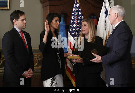 Washington, DC, USA. 25th Jan, 2017. United States Vice President Mike Pence (R) swears in Nikki Haley (2nd L) as the U.S. Ambassador to the United Nations January 25, 2017 in Washington, DC, USA. Haley was formerly the Governor of South Carolina. Also pictured are US Senator Marco Rubio (Republican of Florida) (L) and a member of Haley's staff, Rebecca Schimsa. Credit: Win McNamee/Pool via CNP - NO WIRE SERVICE - Photo: Win Mcnamee/Consolidated News Photos/Win McNamee - Pool via CNP Stock Photo