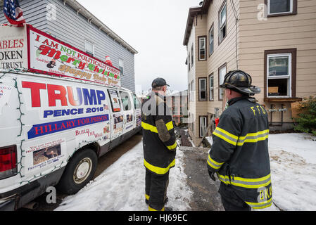Fitchburg, Massachusetts, USA. 26th Jan, 2017. Firefighters look on at 2nd fire at the 'Trump House' at 19-21 West St in Fitchburg Mass. A fire on December 22nd was deemed accidental due to smoking materials in an outside couch. The building was unoccupied at the time of this morning's fire which was reported around 6:00 am. Credit: Jim Marabello/ Alamy Live News Stock Photo