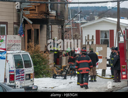 Fitchburg, Massachusetts, USA. 26th Jan, 2017. Local and state fire investigators outside the so-called 'Trump House' at 19-21 West St in Fitchburg Mass. after the second fire in a month damaged the rear of the building. The damage above in this photo was from a fire on December 22nd, which was deemed accidental due to smoking materials in an outside couch. The building was unoccupied at the time of this morning's fire which was reported around 6:00 am. Credit: Jim Marabello/ Alamy Live News Stock Photo
