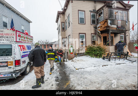 Fitchburg, Massachusetts, USA. 26th Jan, 2017. Local and state fire investigators outside the so-called 'Trump House' at 19-21 West St in Fitchburg Mass. after the second fire in a month damaged the rear of the building. The damage above in this photo was from a fire on December 22nd, which was deemed accidental due to smoking materials in an outside couch. The building was unoccupied at the time of this morning's fire which was reported around 6:00 am. Credit: Jim Marabello/ Alamy Live News Stock Photo