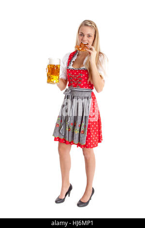 blonde woman in dirndl bites in breze. Stock Photo